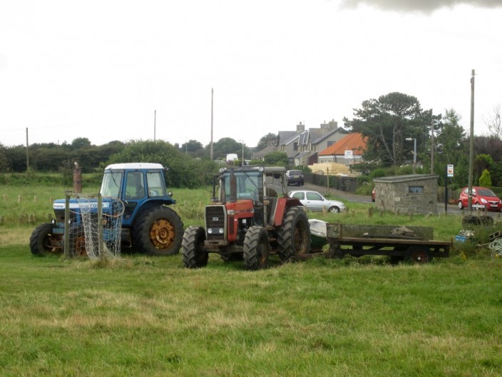 A pair of tractors and trailers at Boulmer